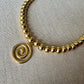 70s retro swirl necklace in gold