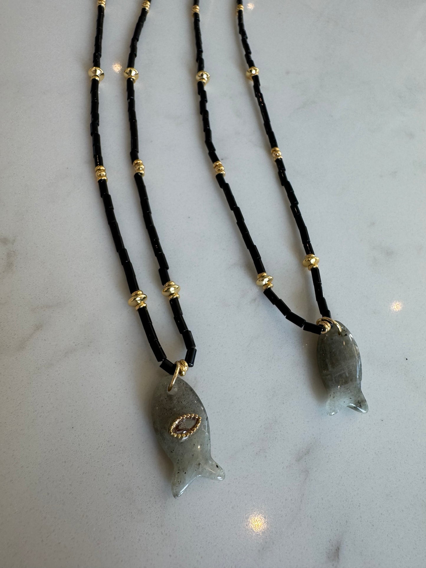 Black fish charm necklace